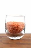 red lentils in glass on wooden table