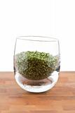dried chive in glass on wooden table