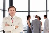 Senior Businessman standing in Front of Business team