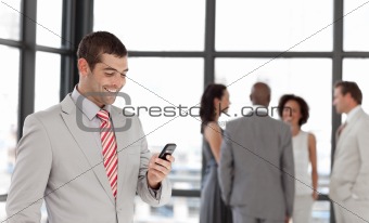 Smiling Businessman sending a text message