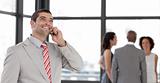 Businessman on the phone in front of business team