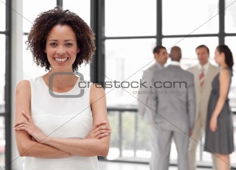 Potrait of a Beautiful Business woman smiling in from of Business team
