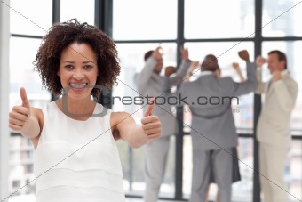 Smiling business woman showing team spirit 