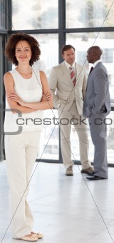Business woman with Folded arms in Front of Business team 