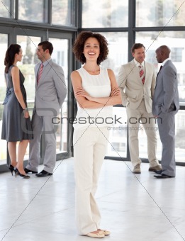 Business woman with Folded arms in Front of Business team 
