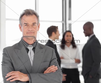 Senior Businessman with team in Background
