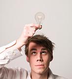 Man with electric light bulb