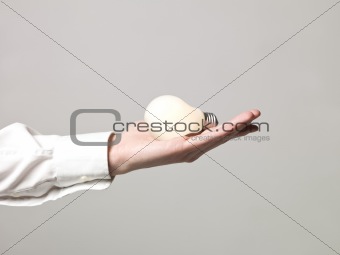 Hand holding light bulb