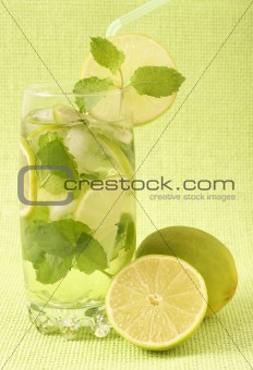 Mojito cocktail on green background