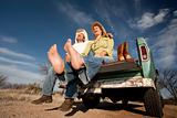 Cowboy and woman on pickup truck
