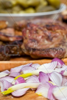 Onions, grilled or barbecued meat and pickled gherkins