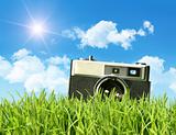 Vintage camera in tall grass