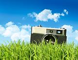 Vintage camera in tall grass