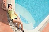 woman laying on the swimming pool edge