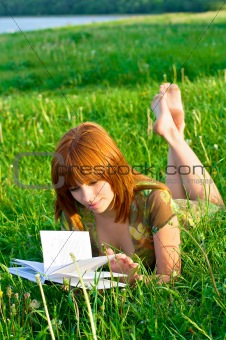 Young beautiful girl reading a book