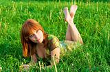 Young beautiful woman laying on the grass