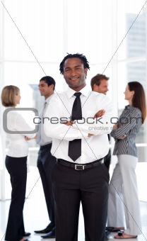 Potrait of a Businessman standing in front of team 
