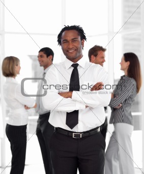 Potrait of a Businessman standing in front of team 