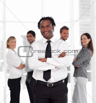 Portrait of a casual business man standing against in front of co-workers