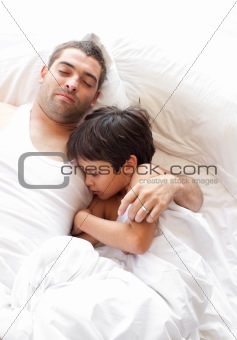 Father and Son Lying on bed 