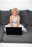 Young girl using a laptop at home