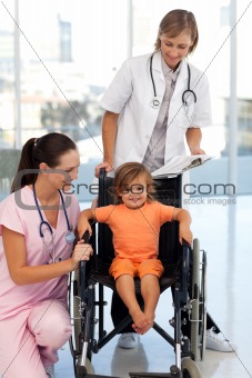 Nurse and doctor with a young patient