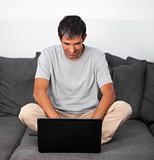 Man working on laptop at home