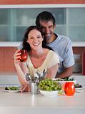 Couple in Kitchen smiling at camera