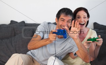 Couple on Sofa Playing Video Games