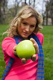 Girl eating apple in a park