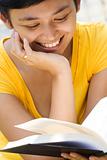 young woman smiling while reading