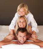 Family lying on bed
