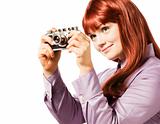 Young woman taking picture with a retro camera