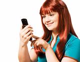 Young woman with mobile phone in hands sending a text message