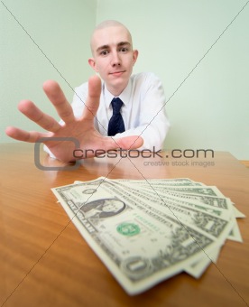 Man reaches for a batch of money