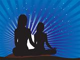 two yogi girls in sitting positions on blue sky background