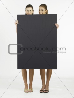 two woman holding  card 