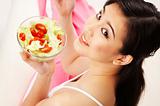 young woman eating salad