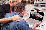 Couple In Kitchen Using Laptop with Stacks of Money and Poker Chips on the Screen.