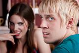 Woman flirting with uninterested male friend