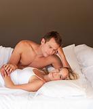 Romantic young couple lying on a bed