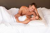 Romantic young couple lying on a bed