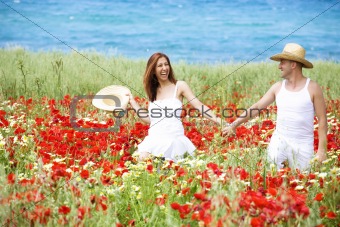 Happy young couple enjoying themselves ona meadow