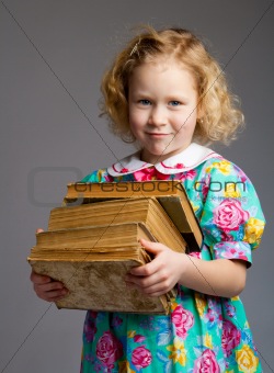 Preschool girl carrying books