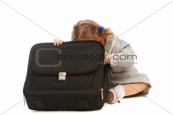 Girl peeping in suitcase