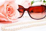 Pink rose, necklace and sunglasses
