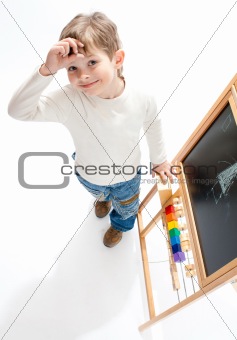Preschool boy near blackboard