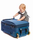 Baby opens suitcase
