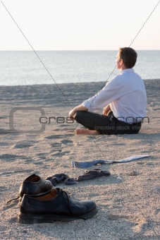 Businessman relaxing on a beach