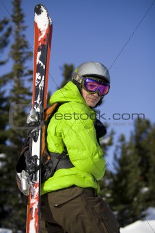 Skier with skis on the back